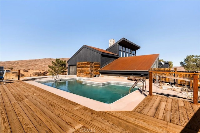 view of swimming pool with a deck with mountain view