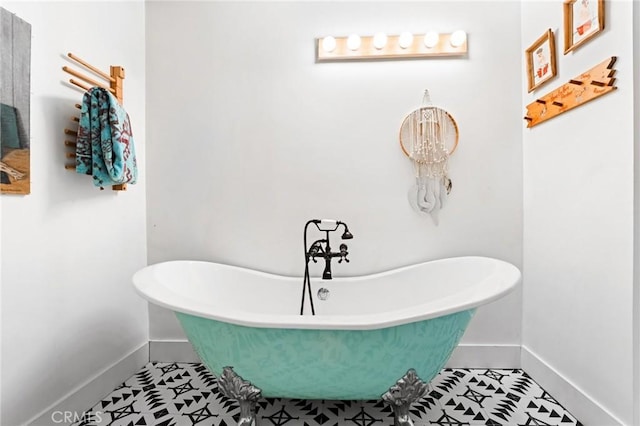 bathroom with tile patterned floors and a washtub