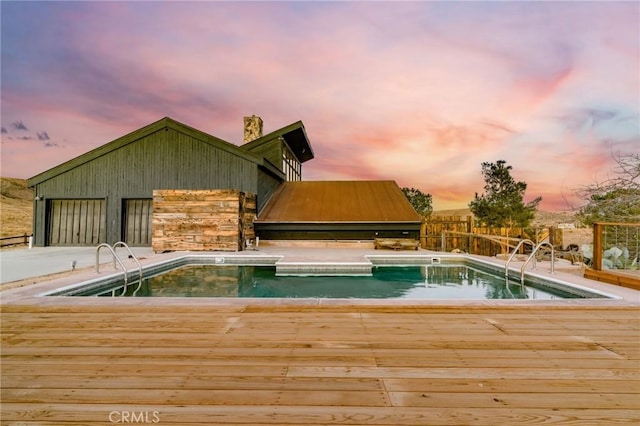 view of pool at dusk