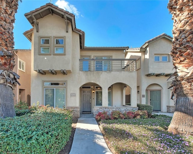 mediterranean / spanish-style home featuring a balcony