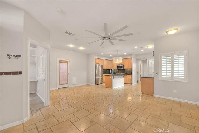 kitchen with a kitchen island, decorative light fixtures, sink, ceiling fan, and stainless steel appliances