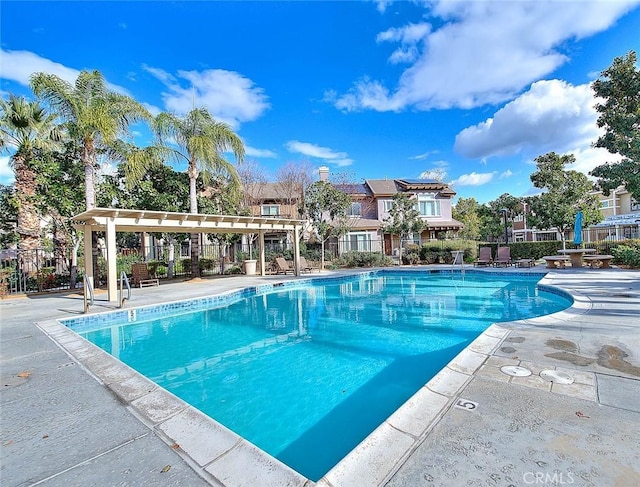 pool featuring a patio area and fence