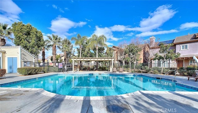 pool featuring a patio, fence, and a pergola