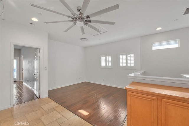 empty room with baseboards, recessed lighting, and a healthy amount of sunlight