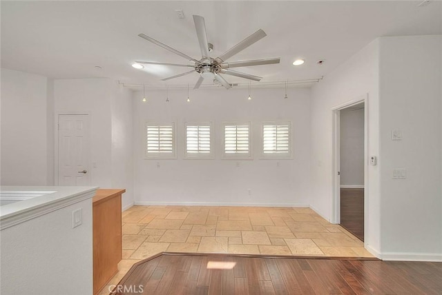 empty room featuring light wood-type flooring, ceiling fan, baseboards, and recessed lighting