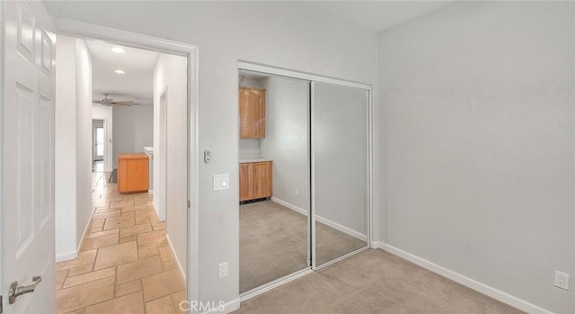 unfurnished bedroom with baseboards, a closet, and stone tile floors