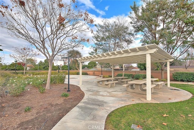 view of home's community featuring fence, a pergola, and a patio