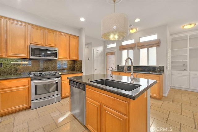 kitchen with stainless steel appliances, recessed lighting, a sink, and stone tile floors