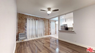 empty room featuring dark hardwood / wood-style flooring and ceiling fan