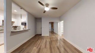 interior space featuring wood-type flooring and ceiling fan