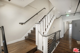 stairway featuring hardwood / wood-style flooring