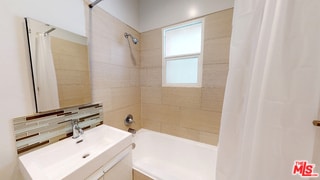 bathroom with sink and shower / tub combo