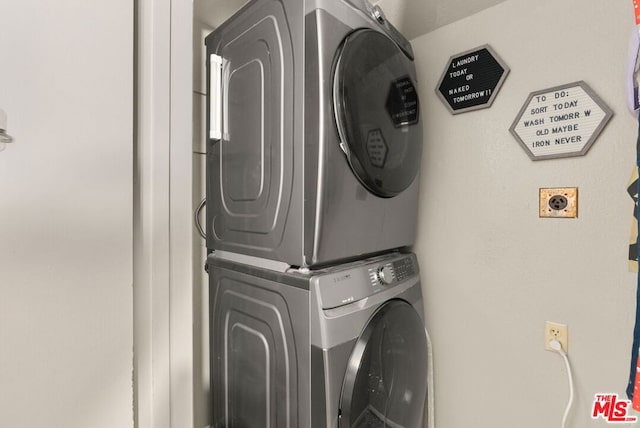 washroom featuring stacked washer / dryer