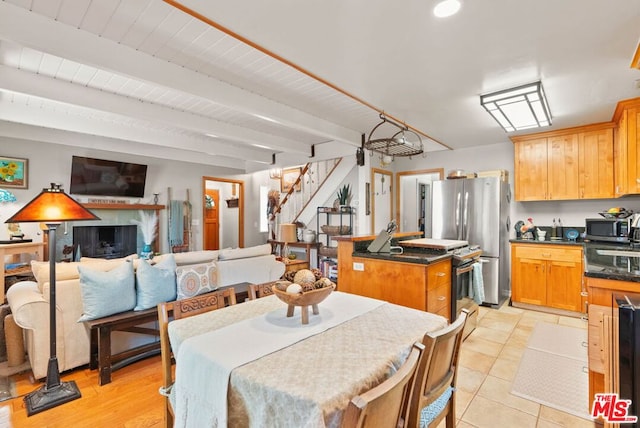 dining area featuring beamed ceiling and wooden ceiling