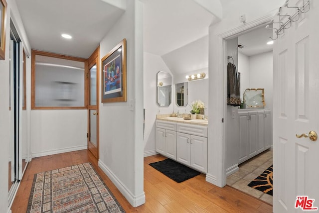 bathroom with vanity and hardwood / wood-style flooring