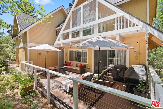 rear view of house with a wooden deck and an outdoor living space