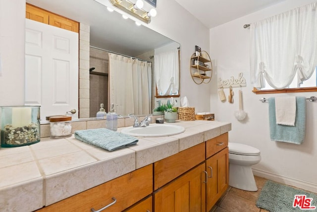 bathroom with vanity, walk in shower, tile patterned floors, and toilet