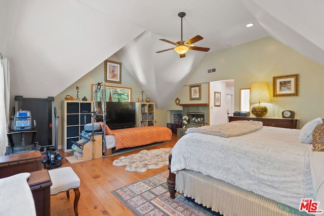 bedroom with hardwood / wood-style flooring, ceiling fan, and lofted ceiling