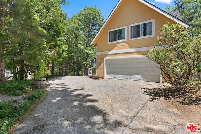 view of side of home with a garage