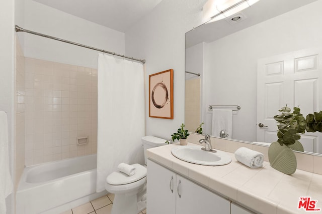 full bathroom with vanity, shower / tub combo, tile patterned floors, and toilet