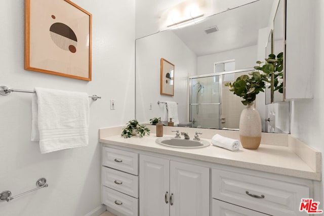 bathroom featuring vanity and walk in shower