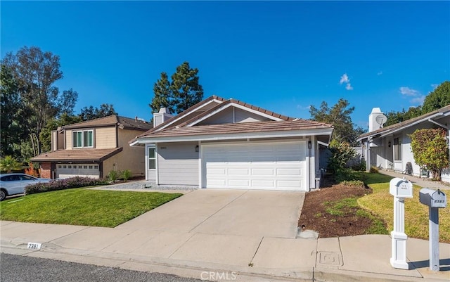 view of front of home featuring a garage and a front lawn