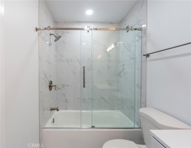 full bathroom with vanity, shower / bath combination with glass door, and toilet