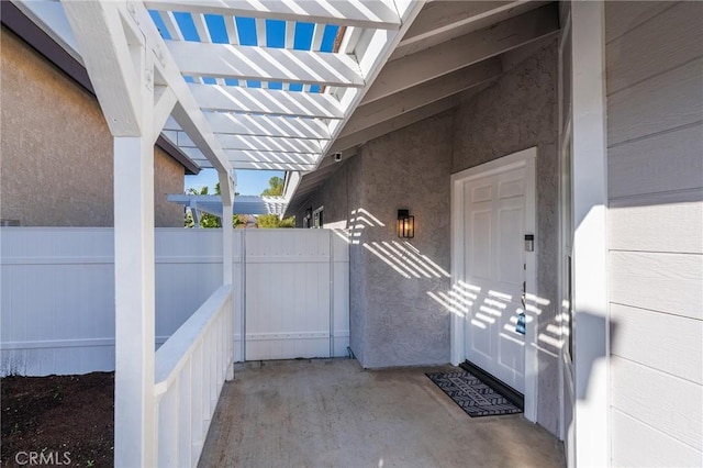 view of exterior entry with a pergola