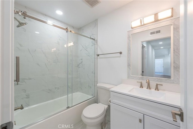 full bathroom featuring vanity, toilet, and combined bath / shower with glass door