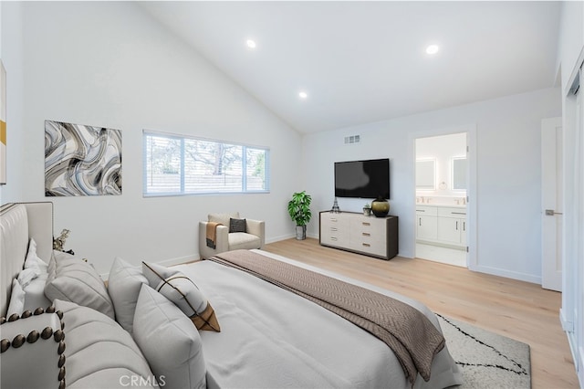 bedroom featuring connected bathroom, high vaulted ceiling, and light hardwood / wood-style floors