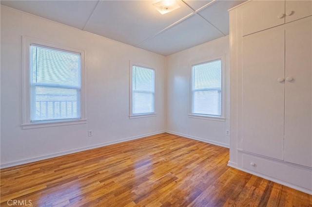 unfurnished room with plenty of natural light and light hardwood / wood-style floors