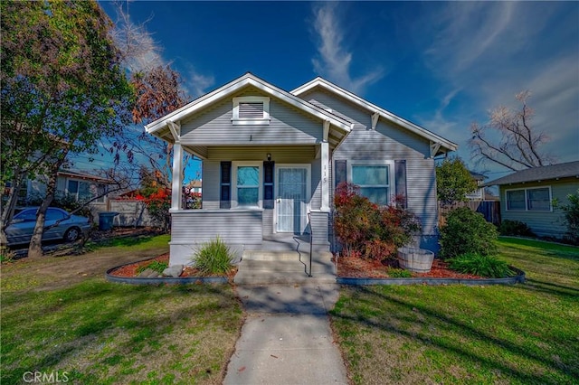 bungalow-style house with a front lawn