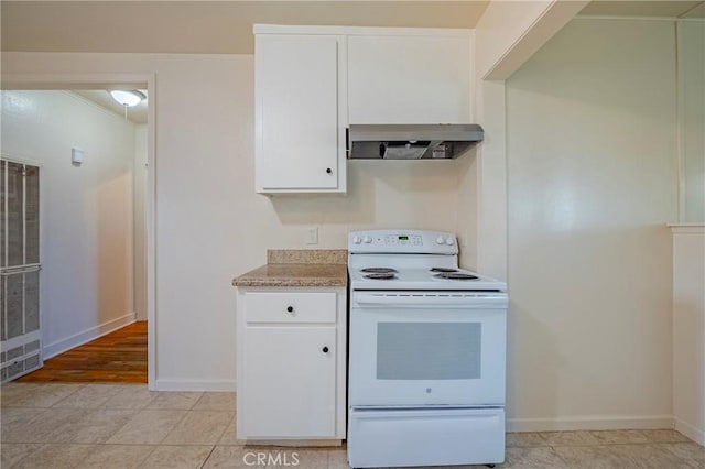 kitchen with white electric stove, exhaust hood, and white cabinets