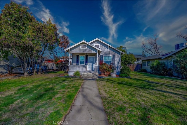 bungalow-style house with a porch and a front lawn