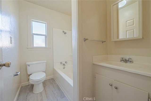 bathroom with vanity, toilet, and hardwood / wood-style floors