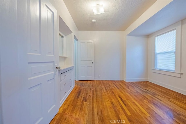 interior space with hardwood / wood-style flooring and a textured ceiling