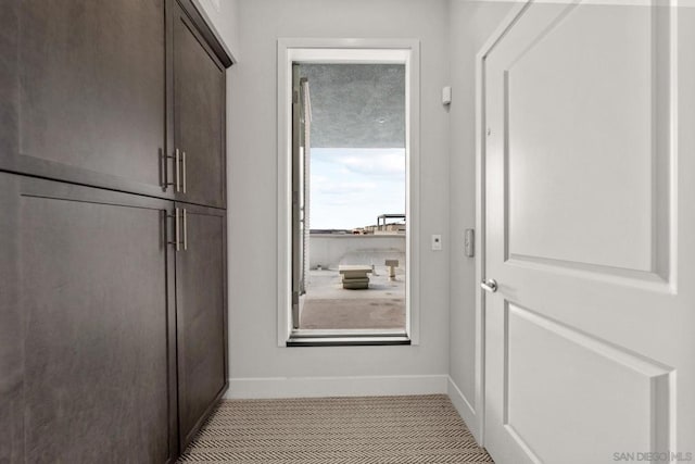 doorway to outside featuring light tile patterned floors