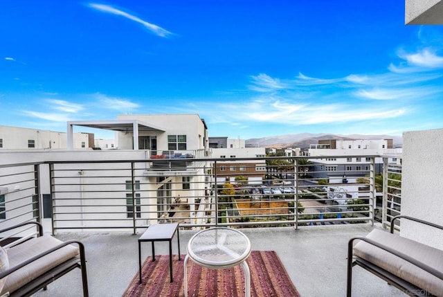 view of patio with a balcony and a mountain view