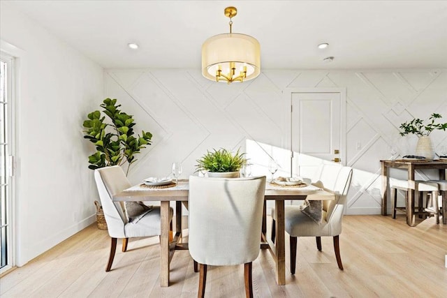 dining room featuring a notable chandelier and light hardwood / wood-style flooring