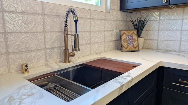 details featuring sink and light stone countertops