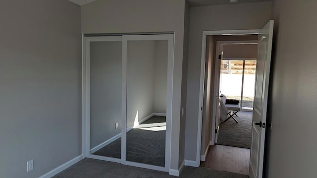 unfurnished bedroom with carpet floors and a closet