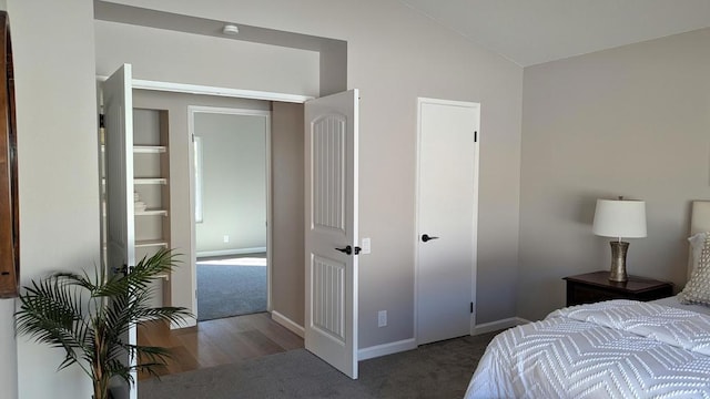 carpeted bedroom with lofted ceiling