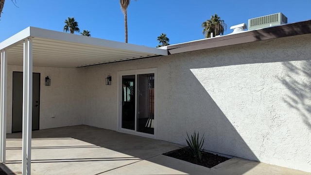 back of property featuring cooling unit and a patio area