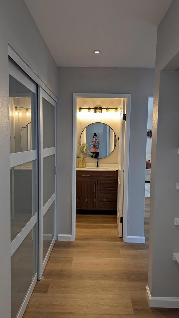 hall with sink and light hardwood / wood-style floors