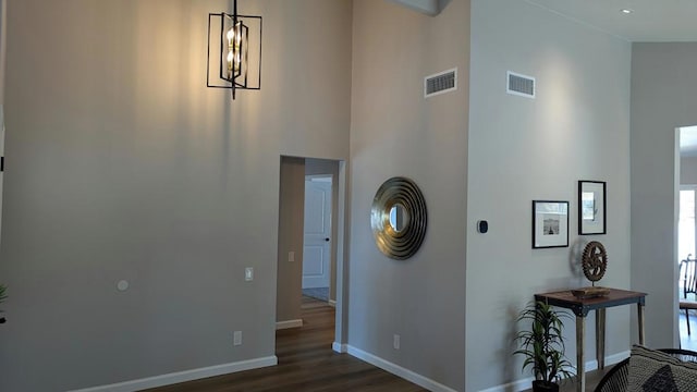 foyer entrance with a high ceiling and dark hardwood / wood-style floors