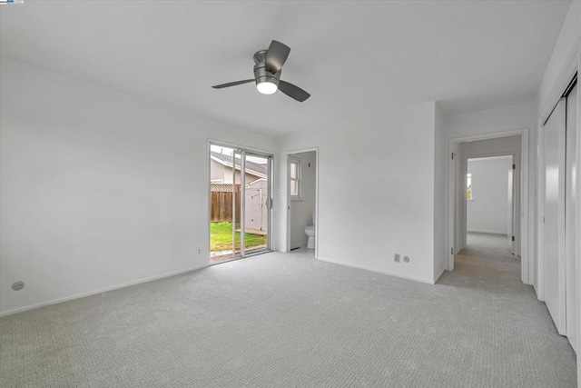 unfurnished room with light colored carpet and ceiling fan