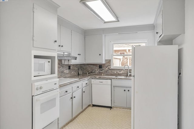 kitchen with tasteful backsplash, sink, white appliances, and white cabinets