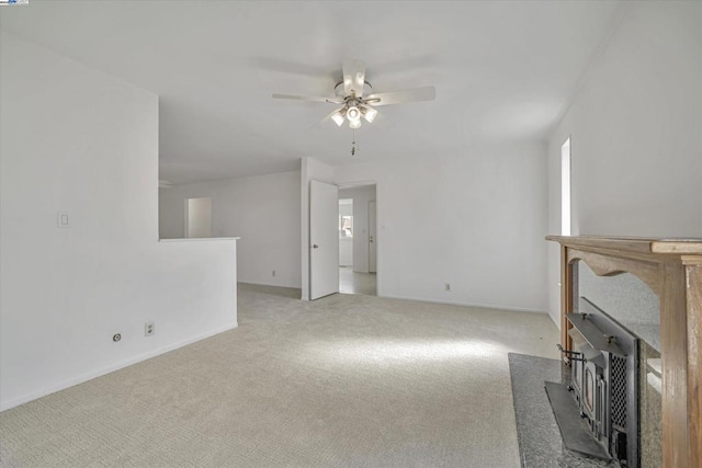 unfurnished living room featuring ceiling fan and light colored carpet