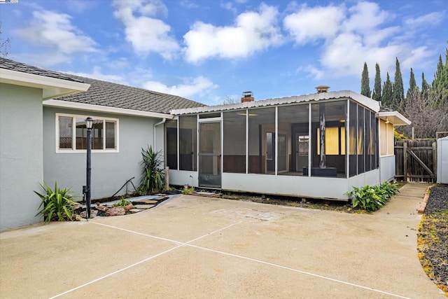 rear view of property featuring a patio area and a sunroom