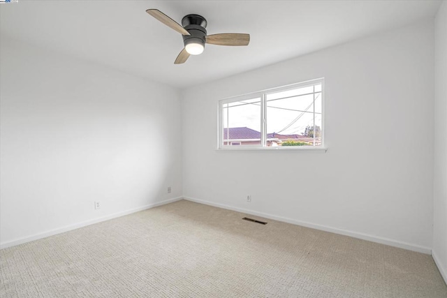 unfurnished room featuring carpet and ceiling fan